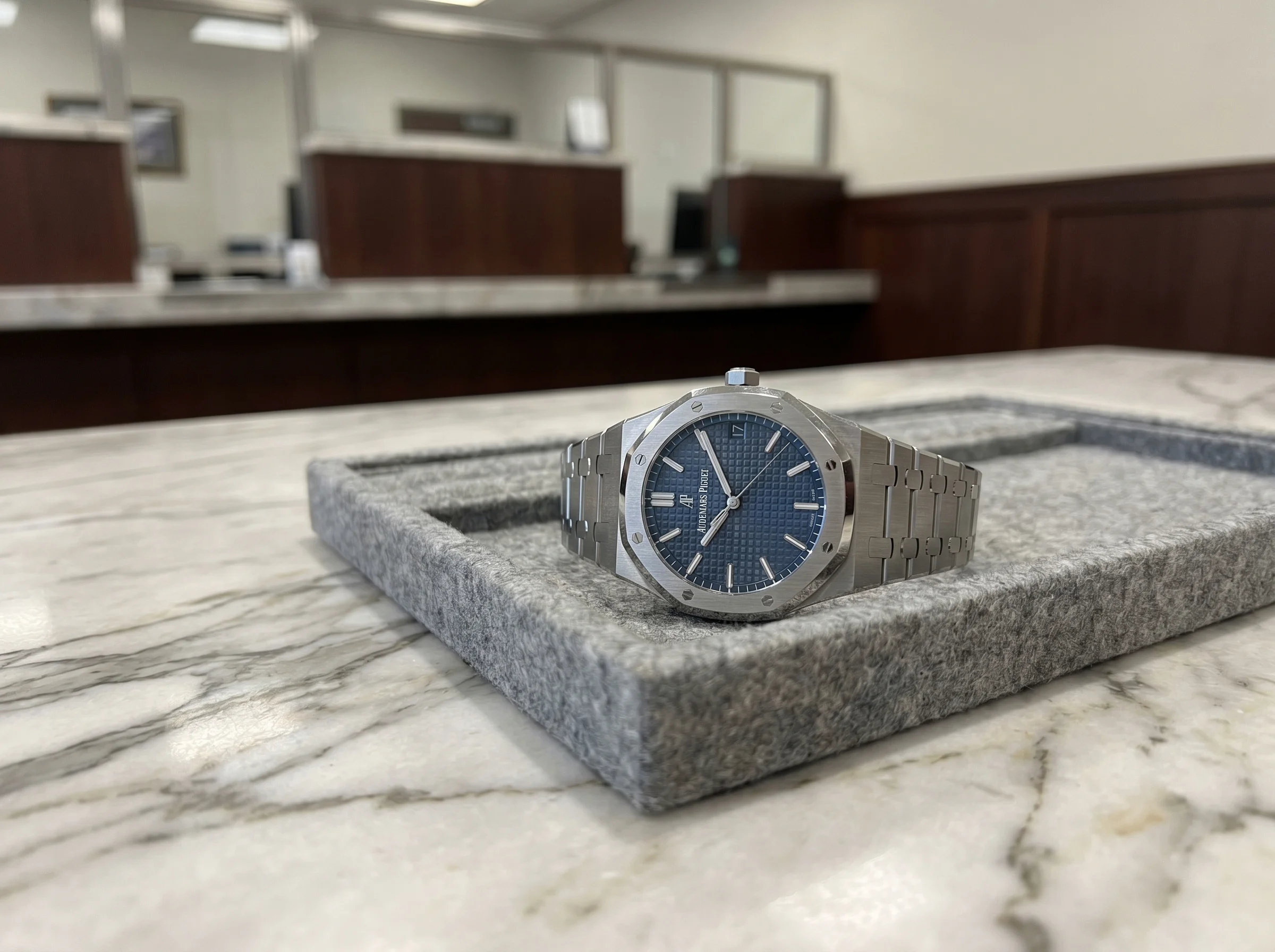 Audemars Piguet Royal Oak 15500ST with blue Grande Tapisserie dial on a grey felt jewelry tray