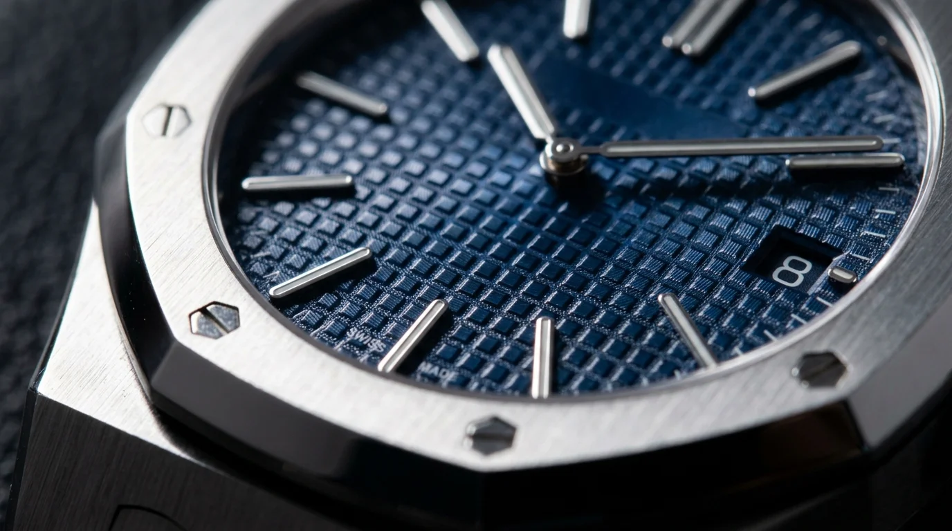 Macro shot of an Audemars Piguet Royal Oak blue dial showing the Petite Tapisserie waffle guilloche pattern
