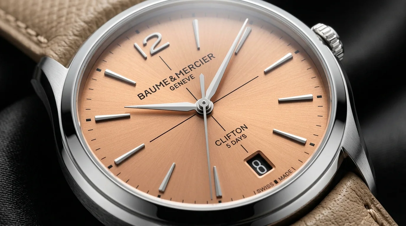 Macro shot of a Baume et Mercier Clifton salmon dial watch showing Clifton 5 Days branding