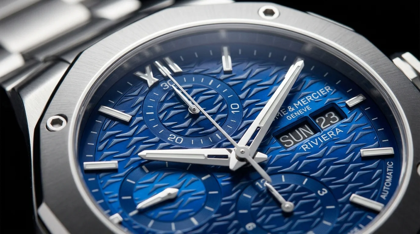 Macro shot of a Baume et Mercier Riviera blue dial chronograph showing the dodecagonal bezel and Riviera branding