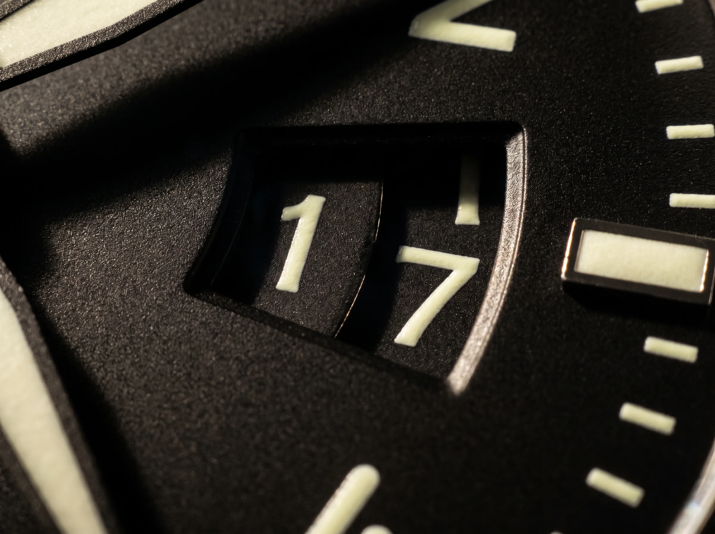 Extreme macro of a big date complication showing two adjacent numeral discs behind a wide aperture