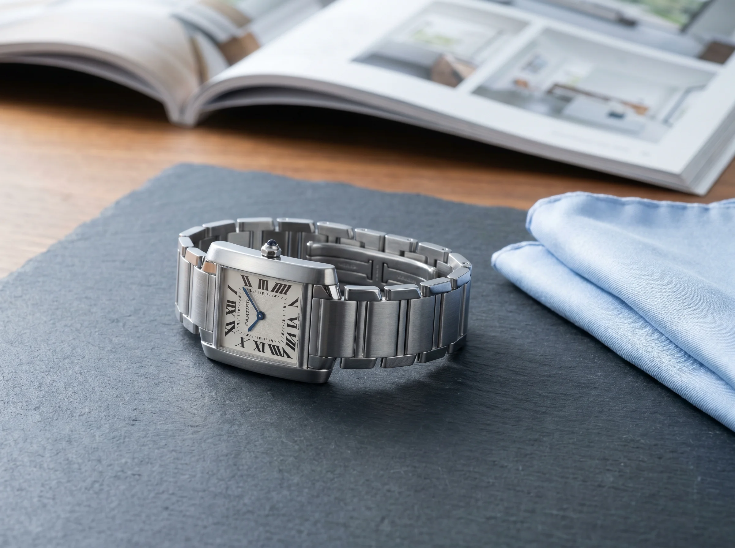 Cartier Tank Française WSTA0067 in stainless steel with the iconic integrated H-link bracelet and silvered opaline dial with Roman numerals
