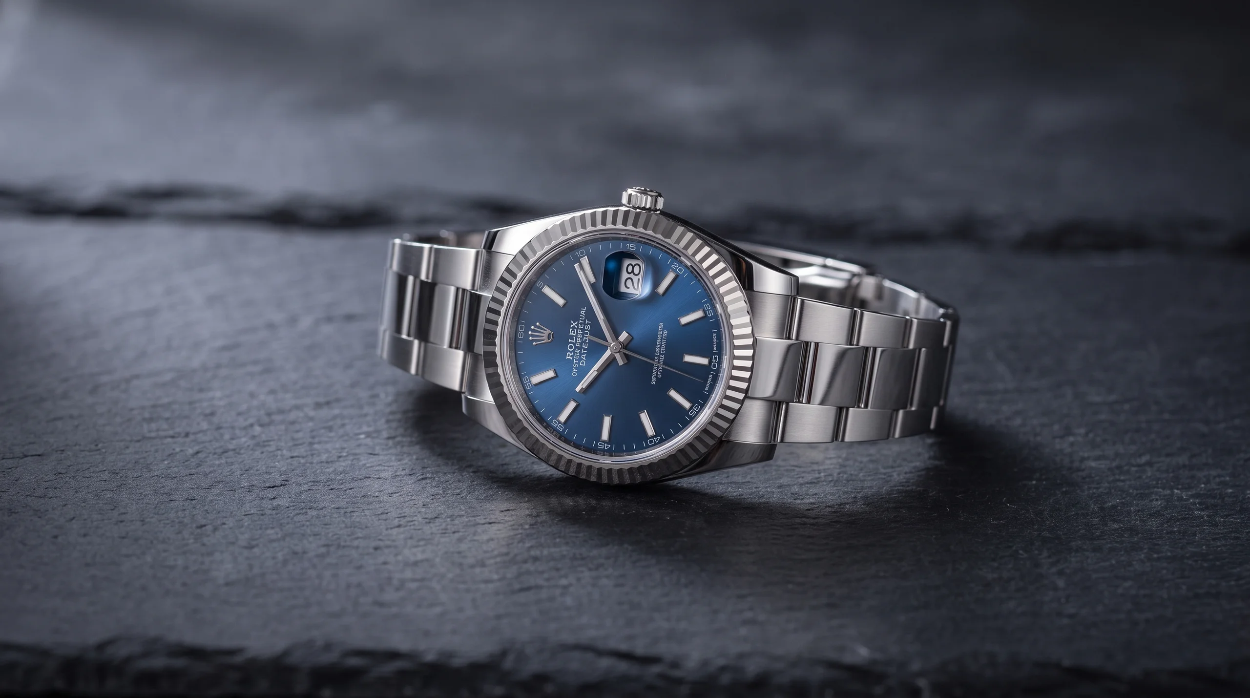 Rolex Datejust in steel with a blue dial and Jubilee bracelet, a Superlative Chronometer, on dark slate