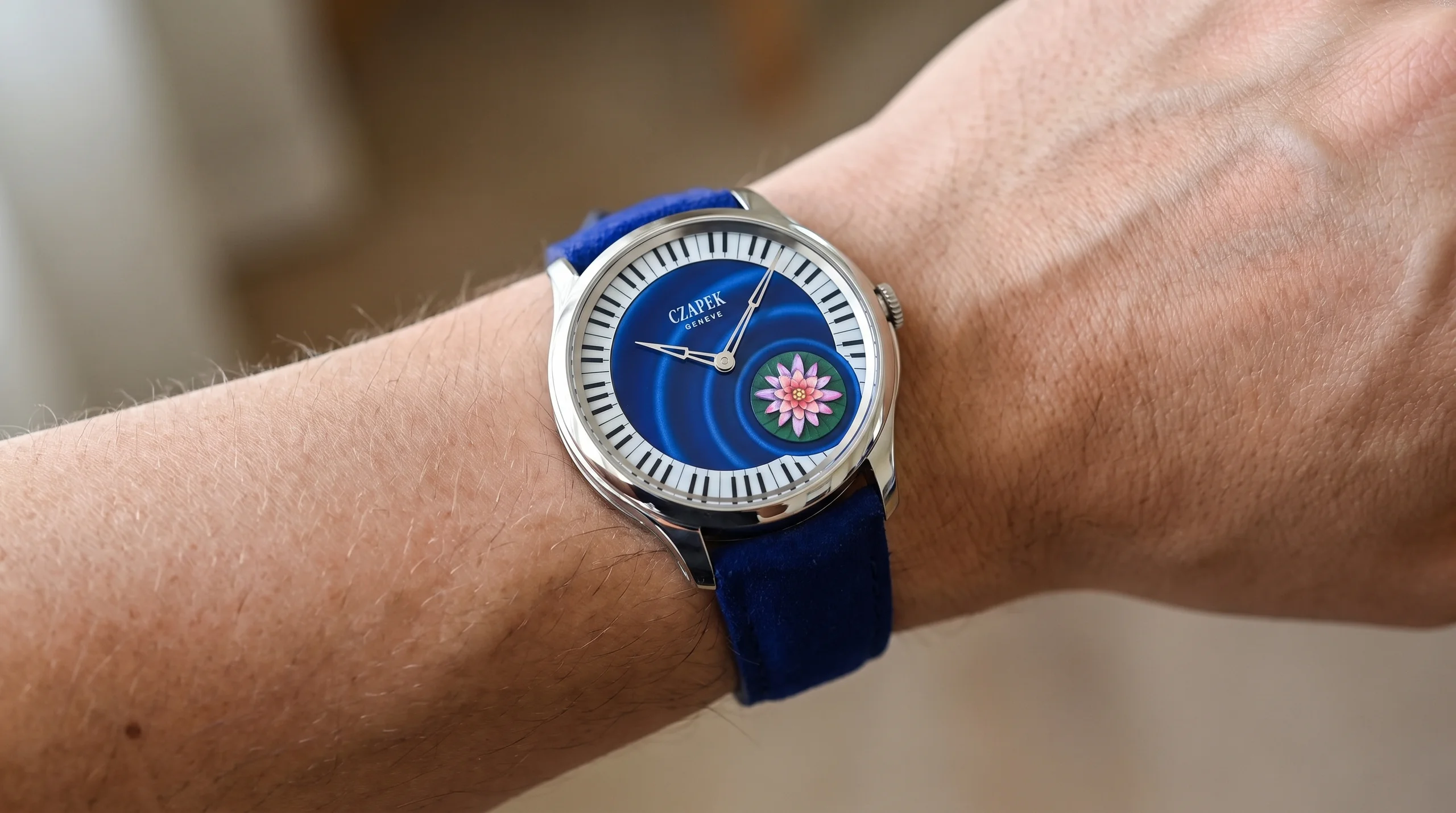 Czapek Promenade L'Ecume des Jours worn on the wrist showing the blue enamel dial and dark blue nubuck strap