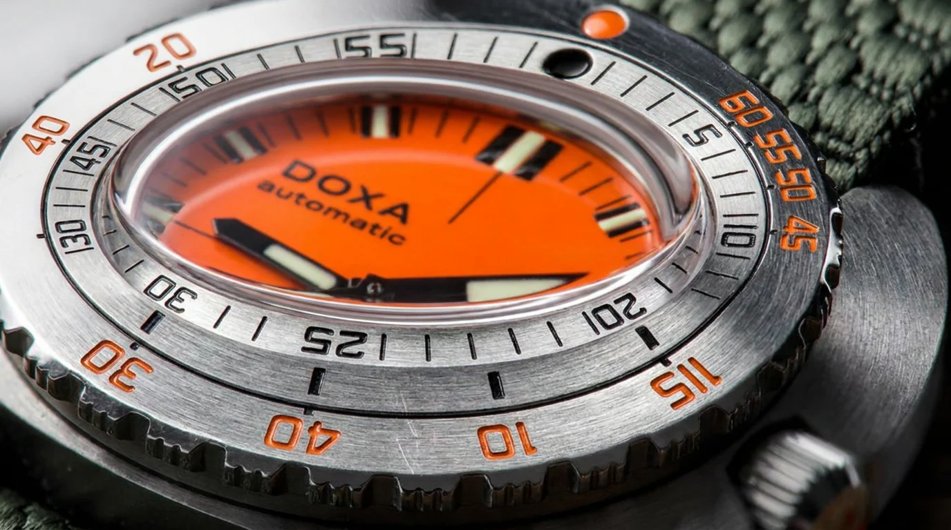 Extreme macro closeup of a Doxa dive watch's no-decompression bezel showing dive-table markings.
