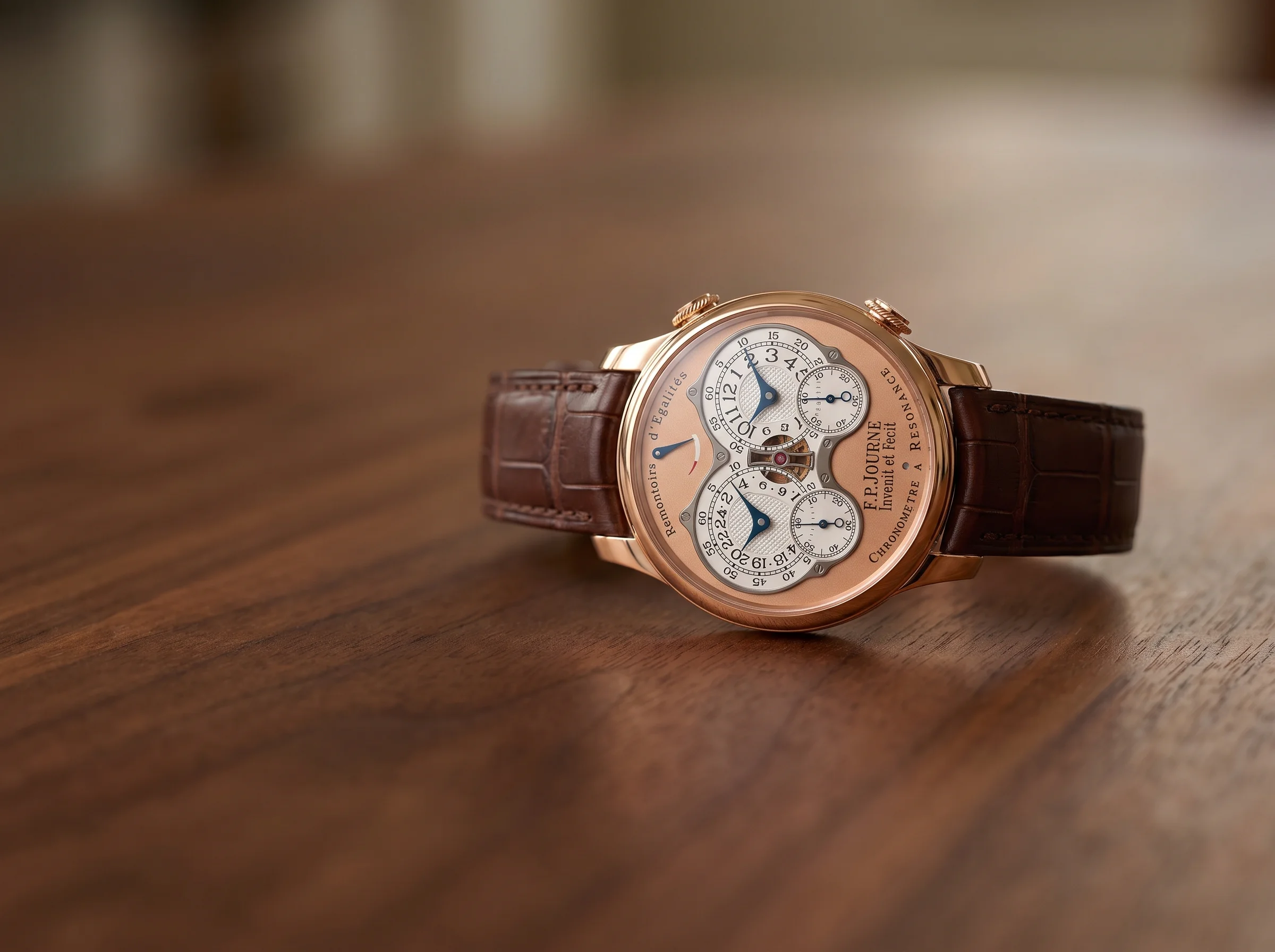 F.P. Journe Chronometre a Resonance in rose gold with its twin-subdial dial on a walnut surface