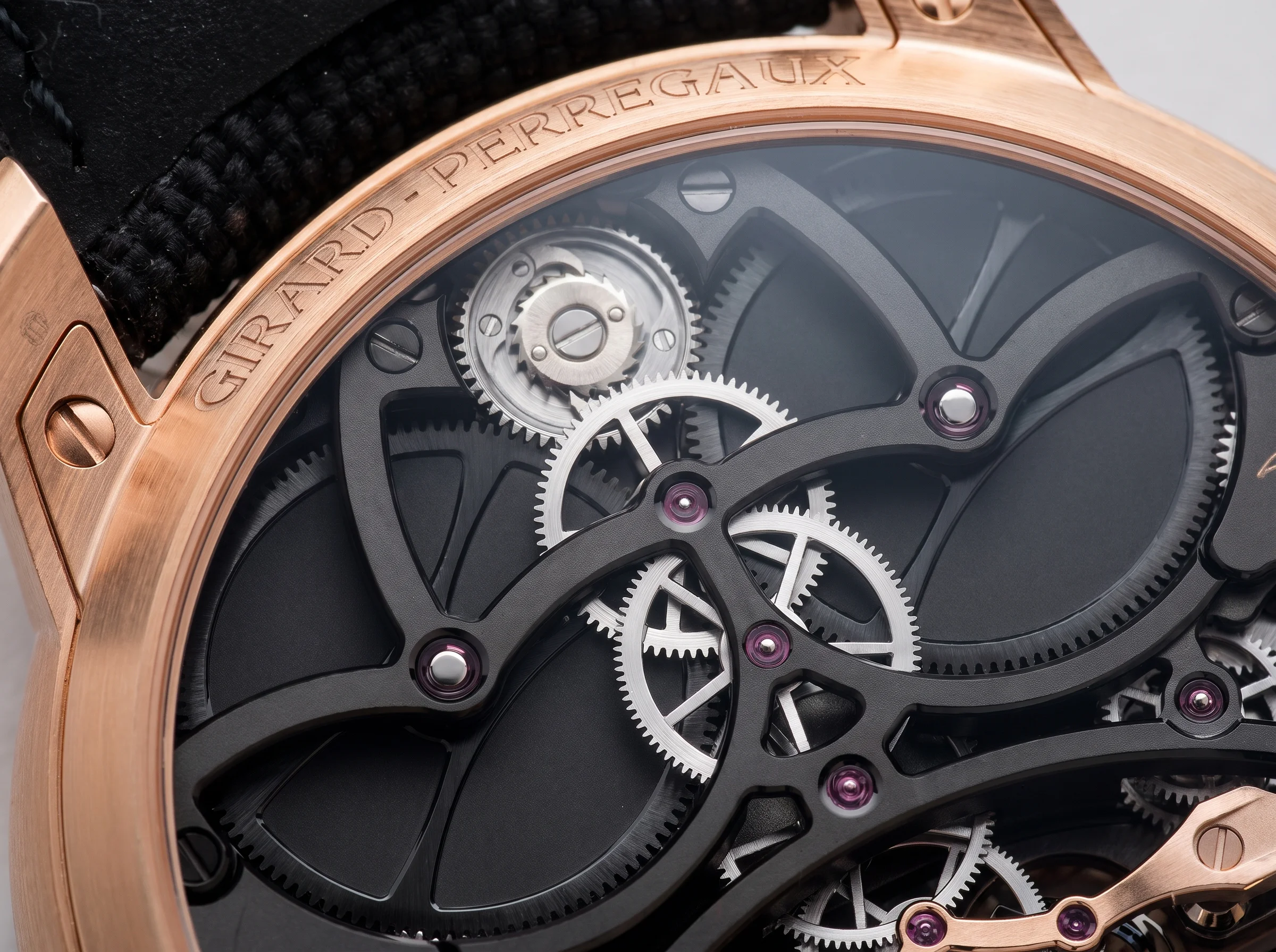 Girard-Perregaux caseback engraved GIRARD-PERREGAUX with the black-coated gear train visible