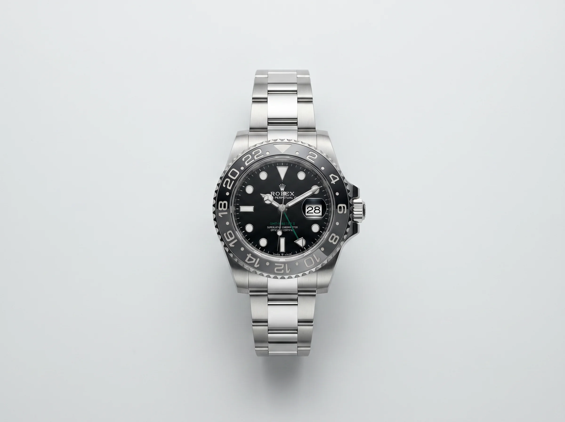 Rolex GMT-Master II Bruce Wayne 126710GRNR with grey and black Cerachrom bezel and green GMT hand, top-down studio view