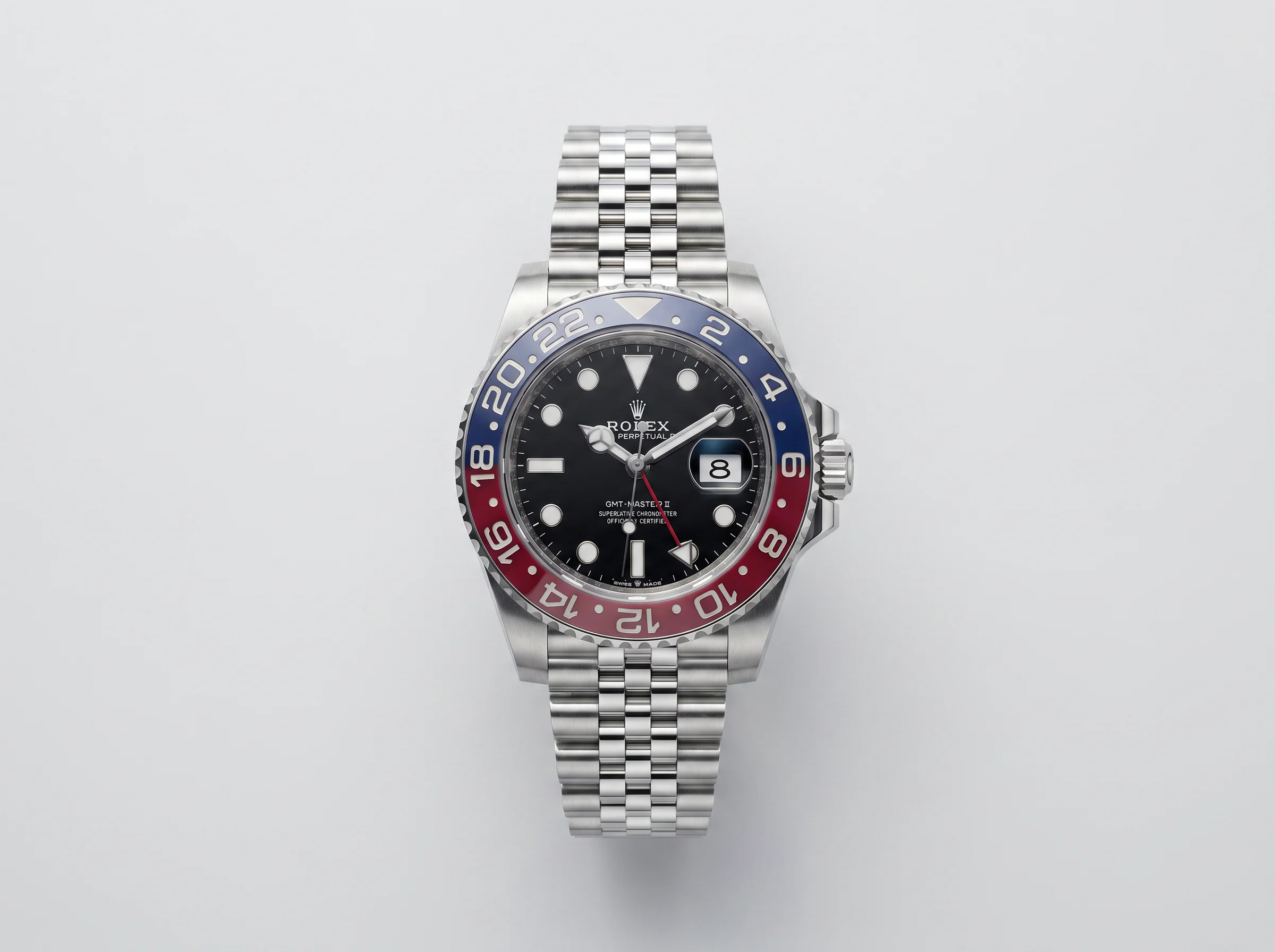 Rolex GMT-Master II Pepsi 126710BLRO with red and blue Cerachrom bezel on Jubilee bracelet, top-down studio view