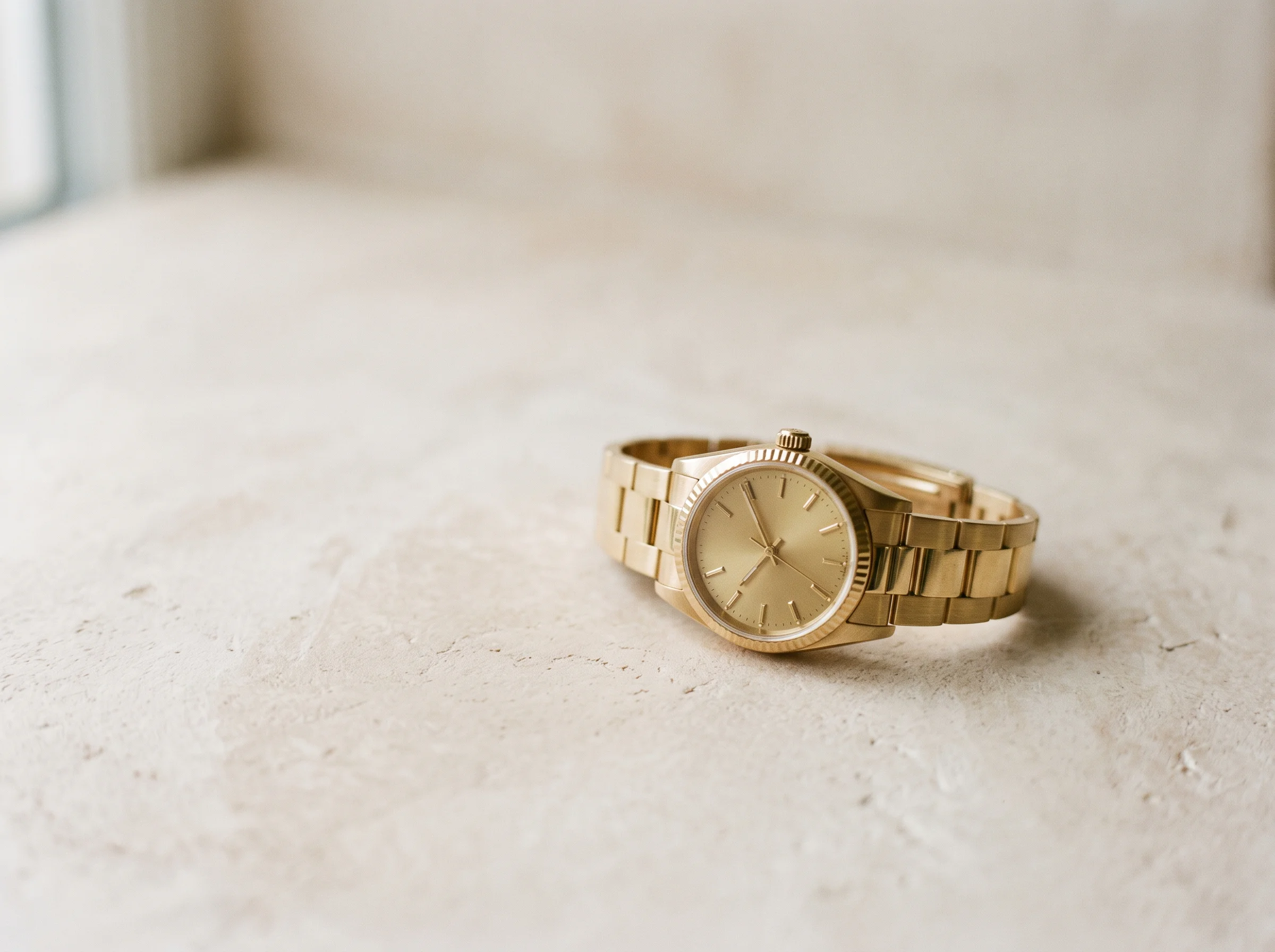 A yellow gold dress-sport watch, representing gold references trading at or below retail