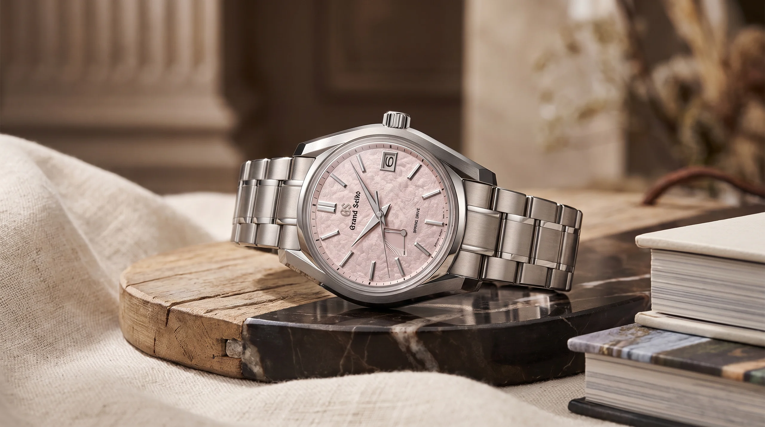 Grand Seiko SBGA529 Peach Blossom editorial product photo showing the frosted pink dial texture