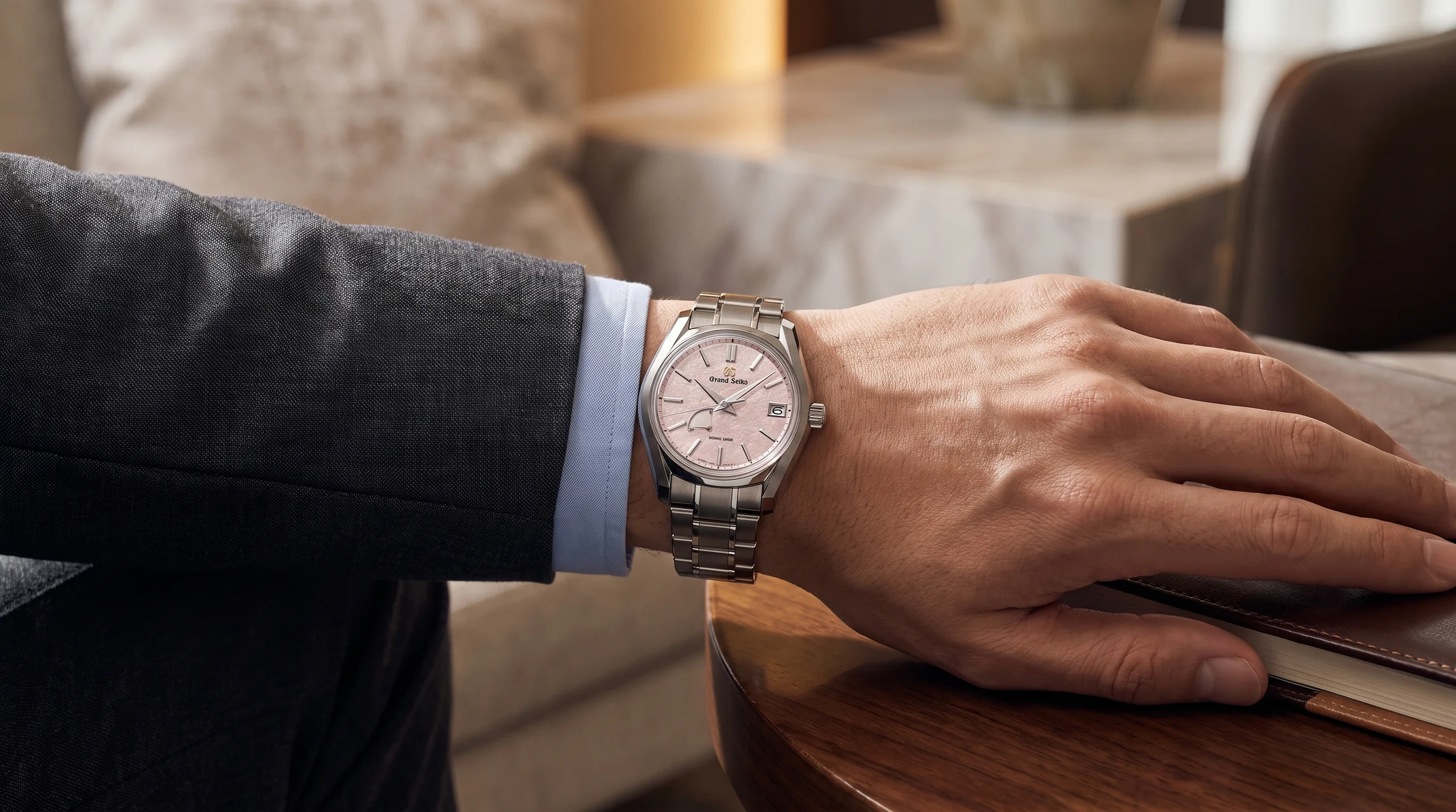 Grand Seiko SBGA529 Peach Blossom worn on the left wrist showing the titanium bracelet