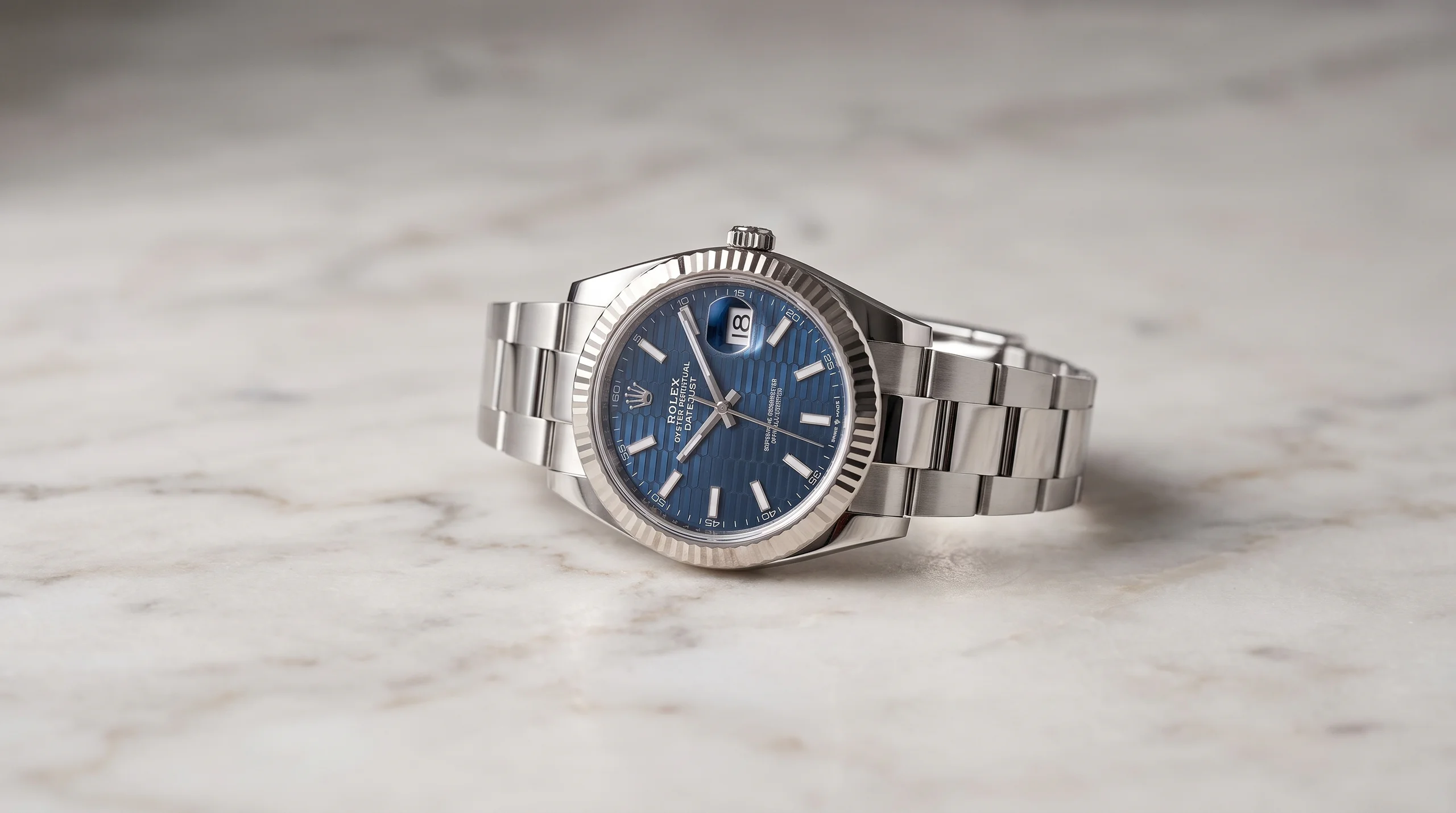 Steel Rolex Datejust 41 with blue fluted dial, the everyday Rolex that holds its value against Grand Seiko