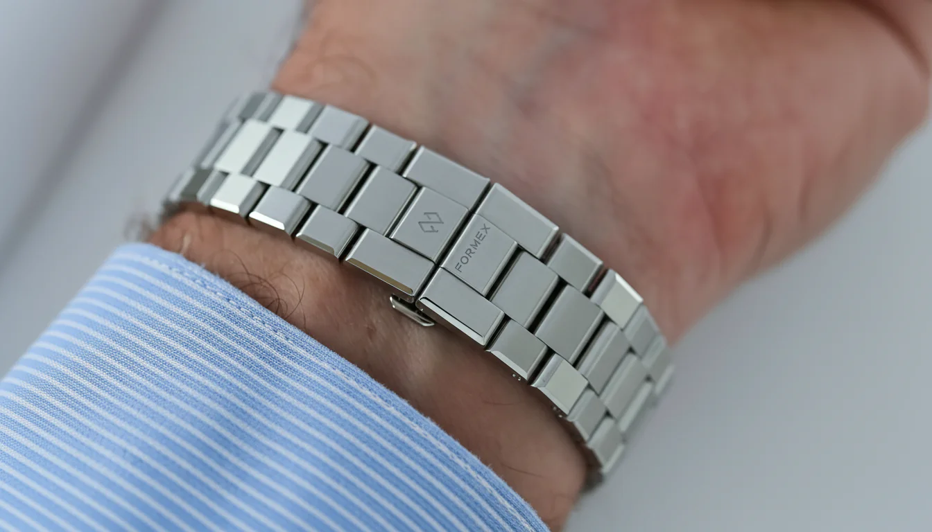 Macro of the Formex Essence bracelet's micro-adjust clasp mechanism, worn on the wrist, with FORMEX engraved on the clasp cover