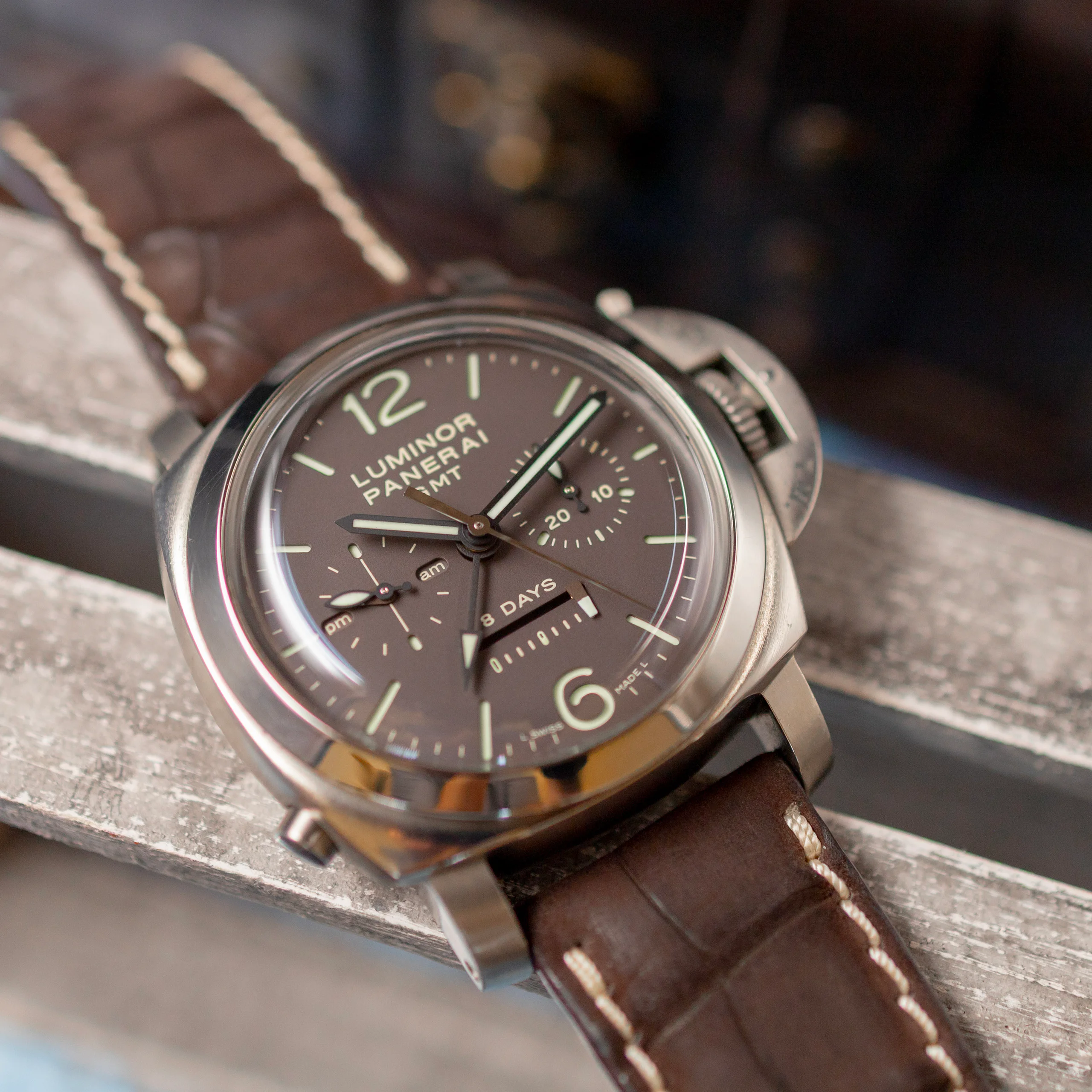 Panerai PAM00311 Monopulsante GMT on the wrist, showing the case-mounted monopusher chronograph button at 8 o'clock