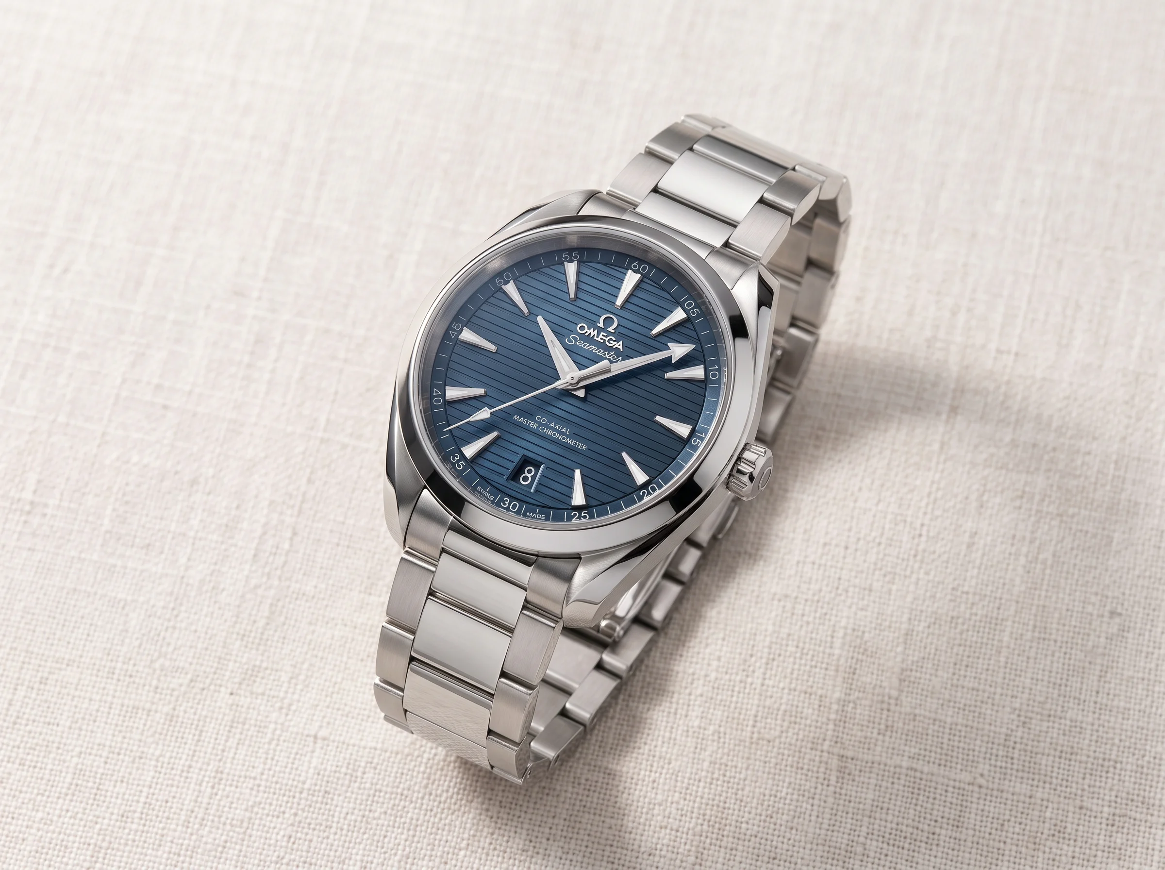 Omega Seamaster Aqua Terra 150M with a blue horizontal teak dial and date at 6 o'clock on a steel bracelet