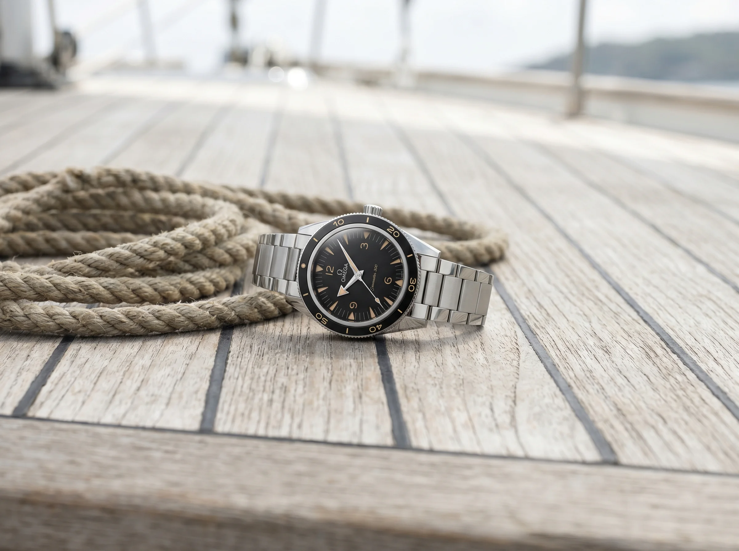 Omega Seamaster 300 heritage in steel with black ceramic bezel and sandwich dial on a teak boat deck