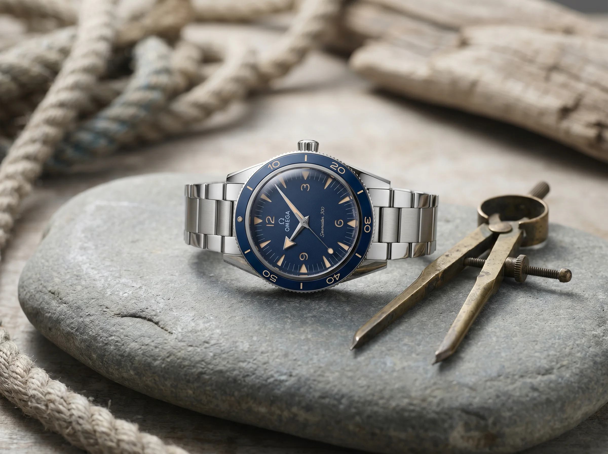 Omega Seamaster 300 heritage in steel with blue ceramic bezel and sandwich dial on grey stone