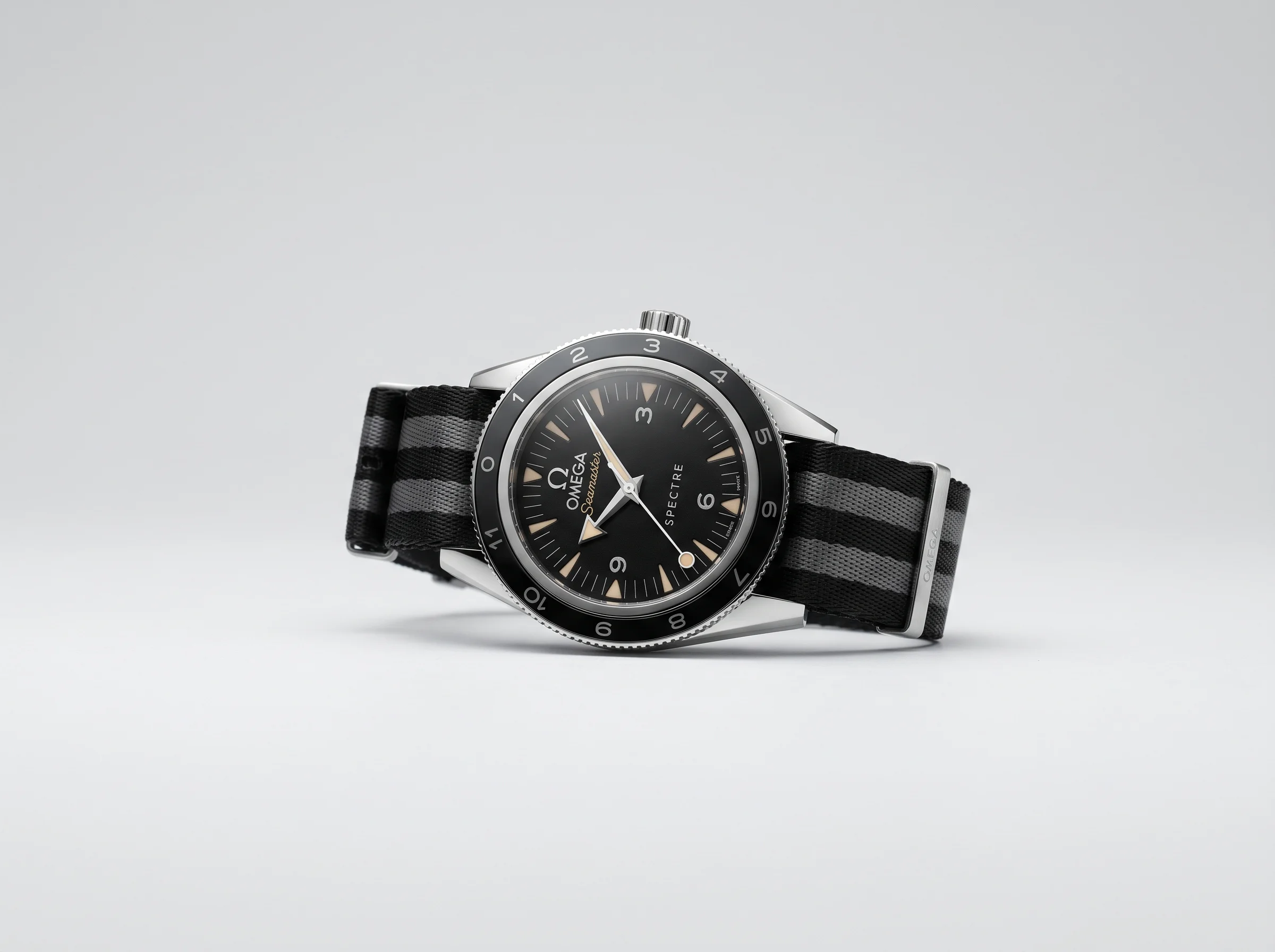 Omega Seamaster 300 Spectre Limited Edition reference 233.32.41 with 12 vintage hour markers, lollipop seconds hand, and black-and-grey striped NATO strap