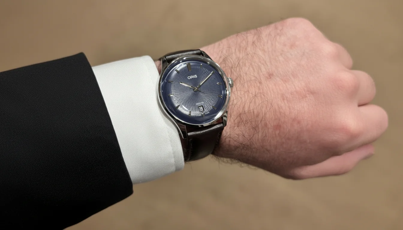 Oris Artelier Date 38mm blue dial worn on the wrist with a suit cuff