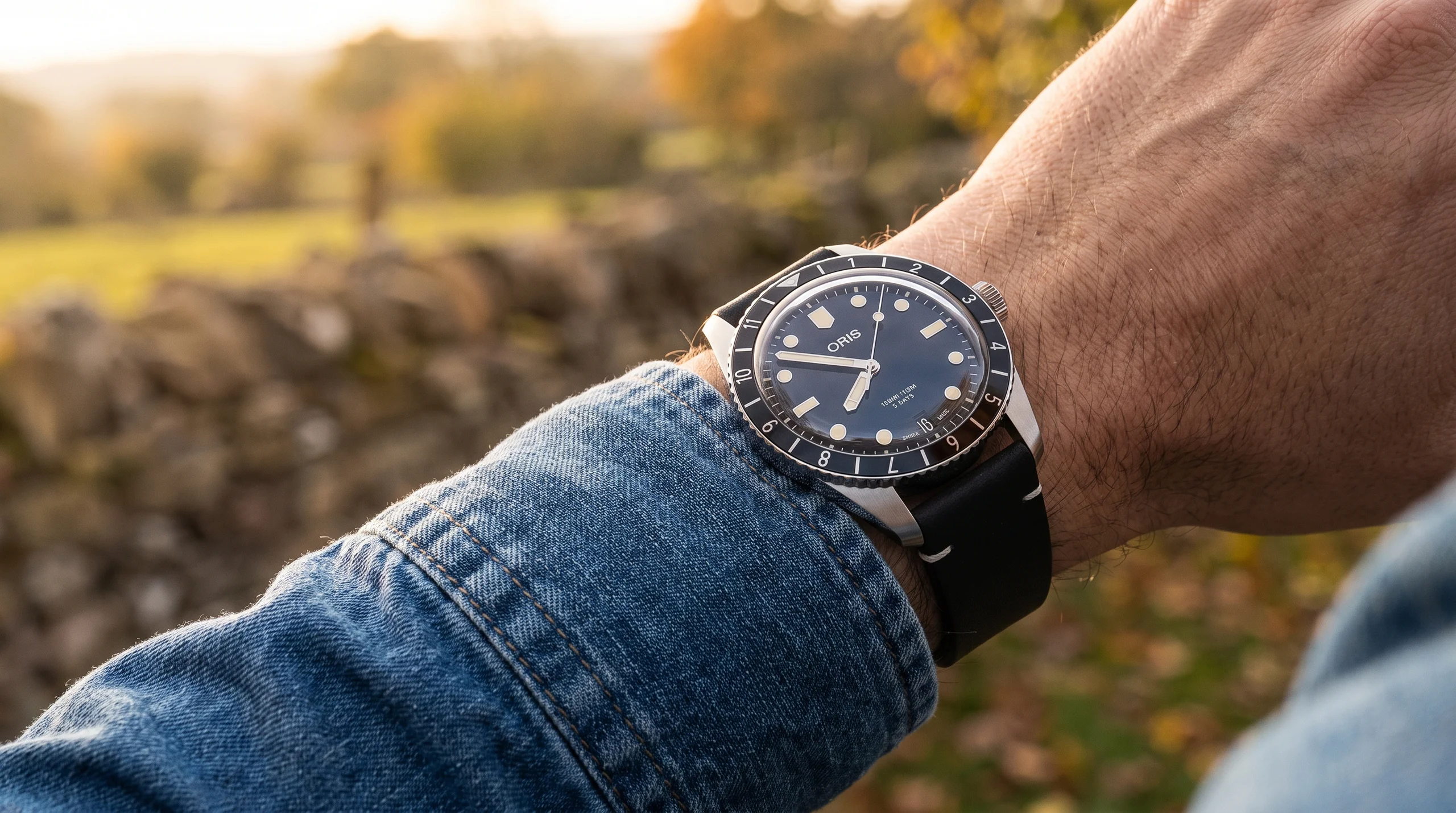Oris Divers Sixty-Five Calibre 400 worn casually over a denim sleeve, the everyday vintage diver