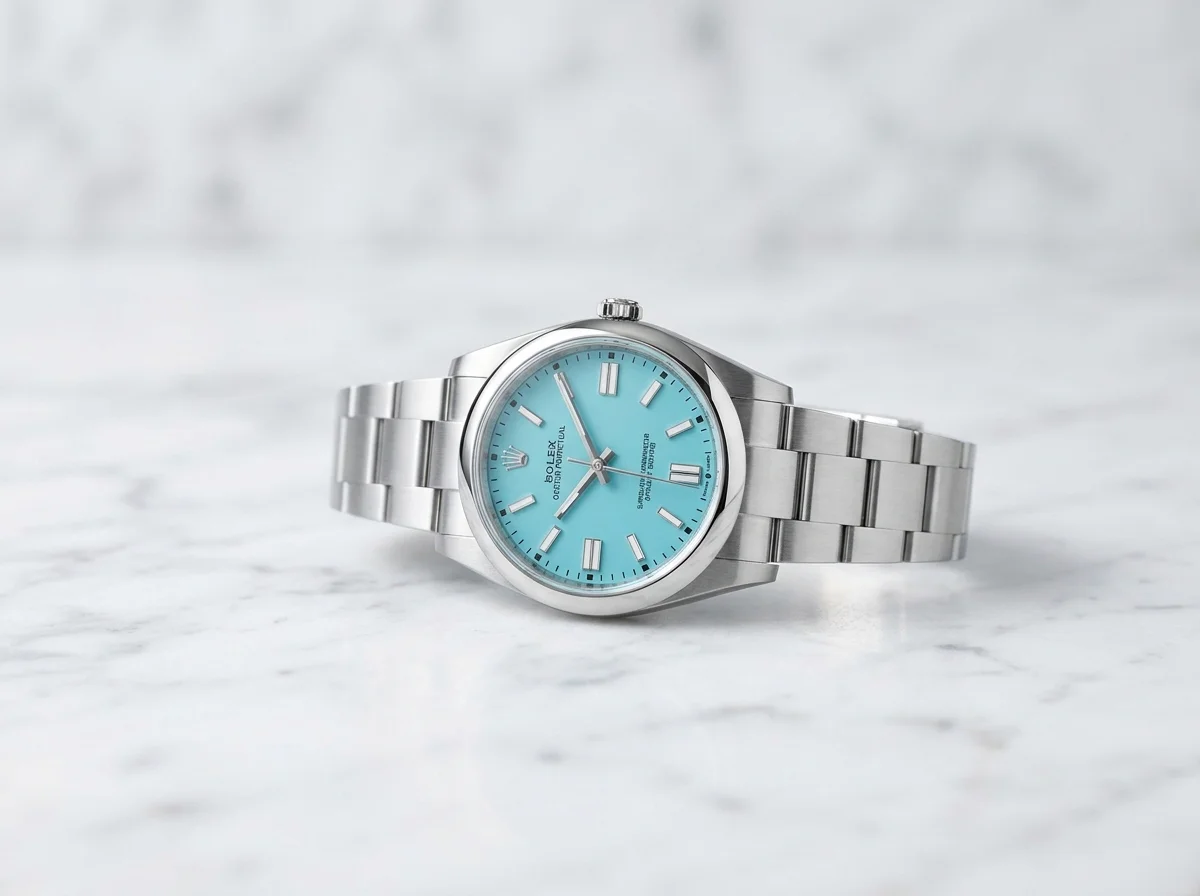 Rolex Oyster Perpetual 41 ref 124300 with vivid turquoise blue dial on white marble, the discontinued dial that commands a premium