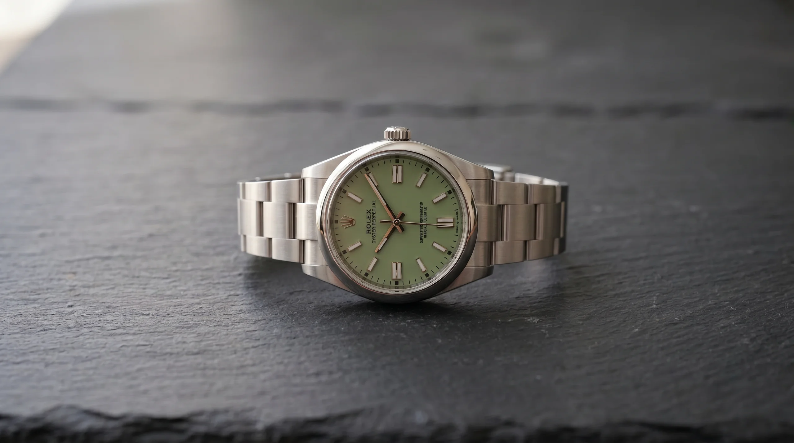 Rolex Oyster Perpetual 41 ref 134300 with pistachio green dial on dark slate, the entry-level Rolex sleeper