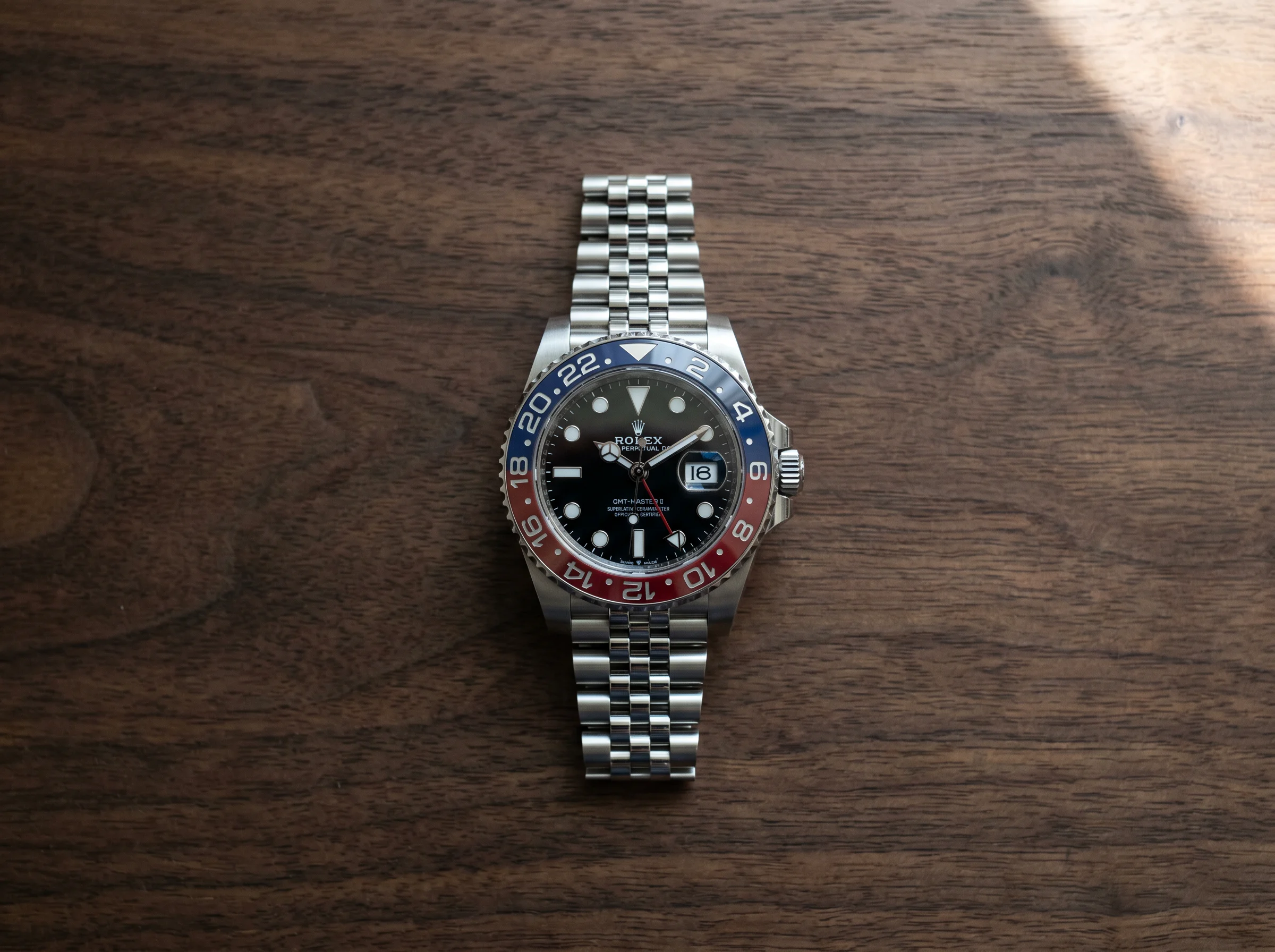 Top-down view of the Rolex GMT-Master II Pepsi 126710BLRO with red and blue Cerachrom ceramic bezel on Jubilee bracelet