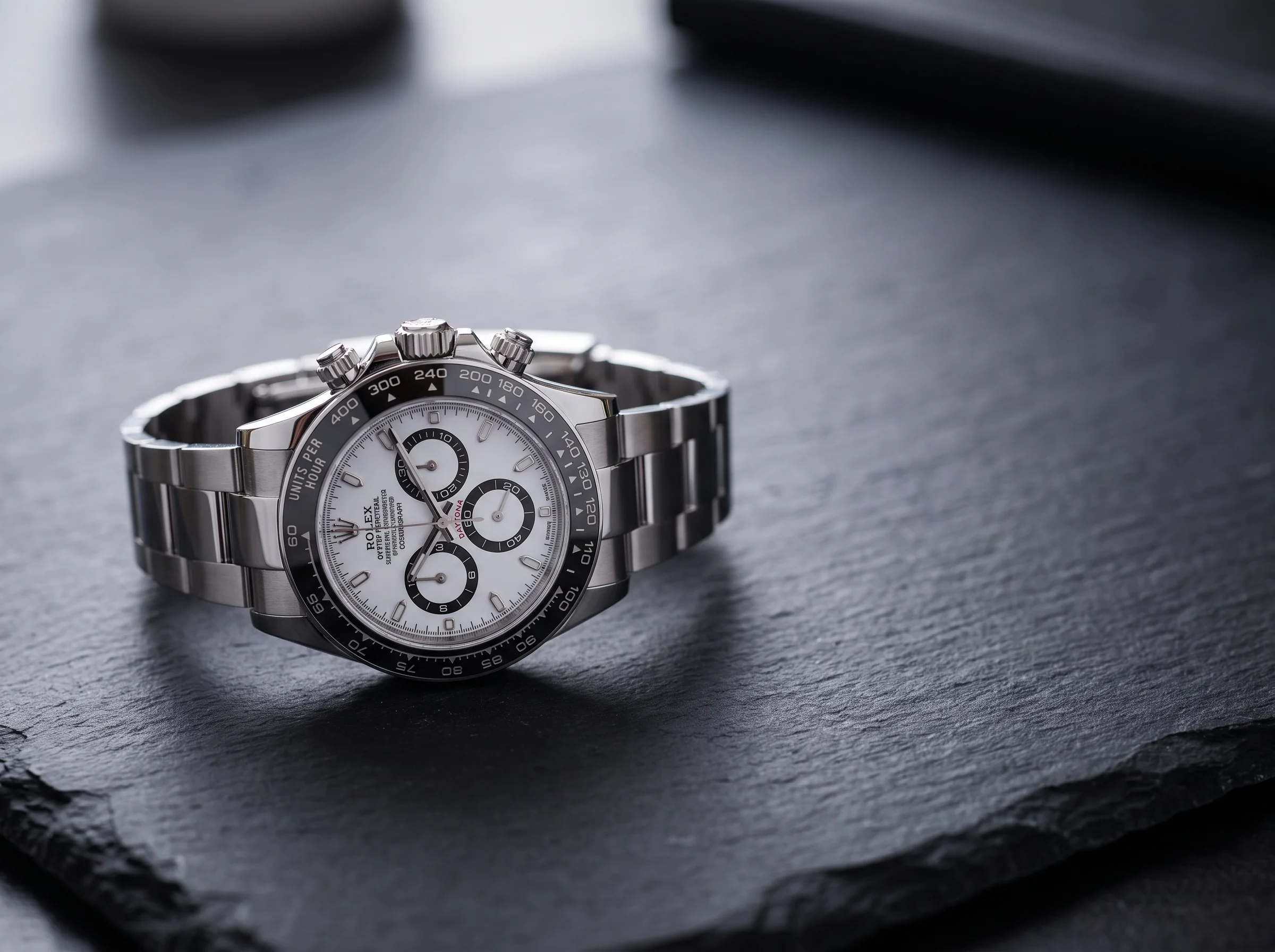 Rolex Cosmograph Daytona Panda 126500LN with a white dial and black sub-dials on dark slate
