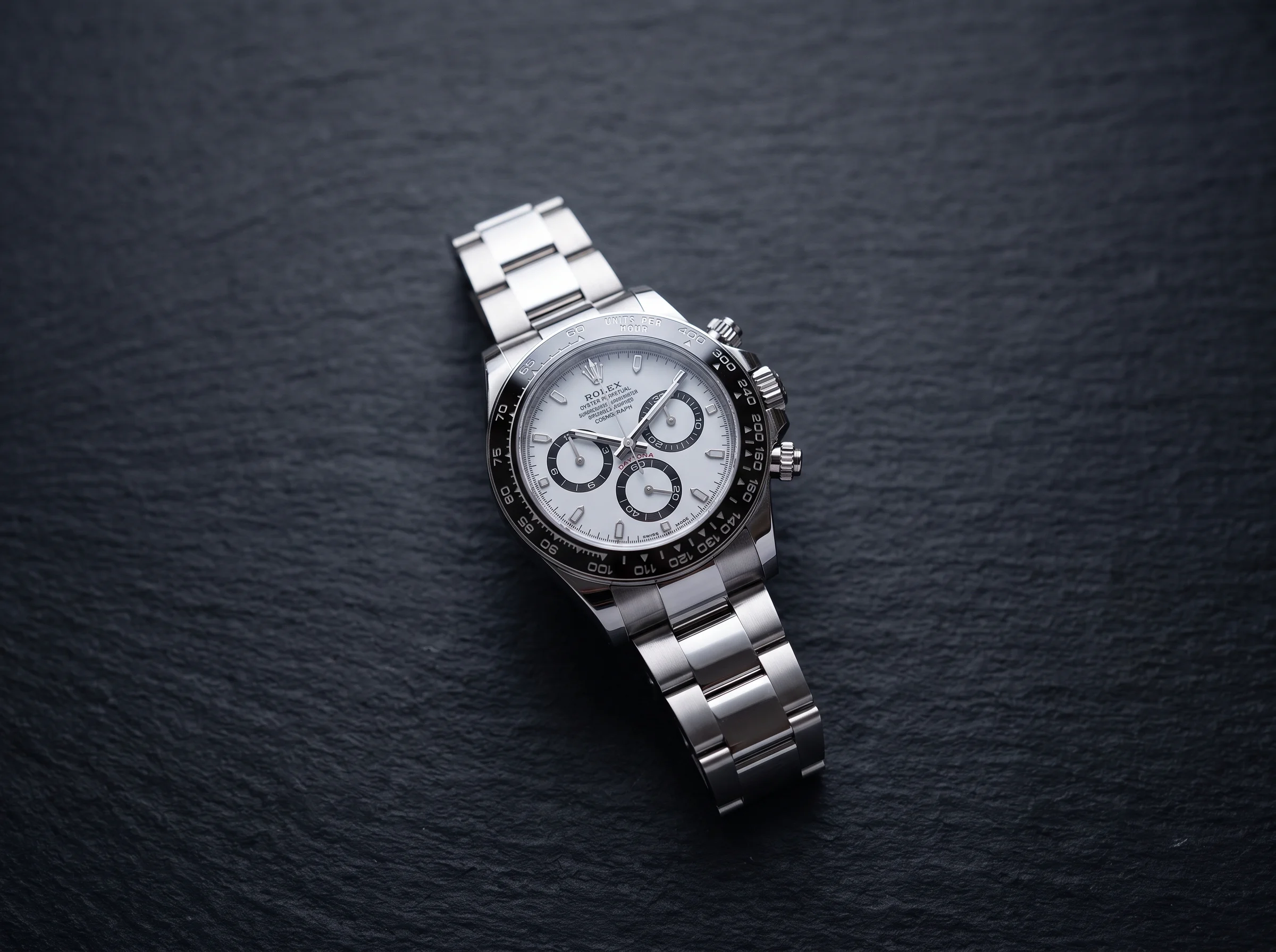 Rolex Cosmograph Daytona 126500LN with a white panda dial and black ceramic bezel on dark slate