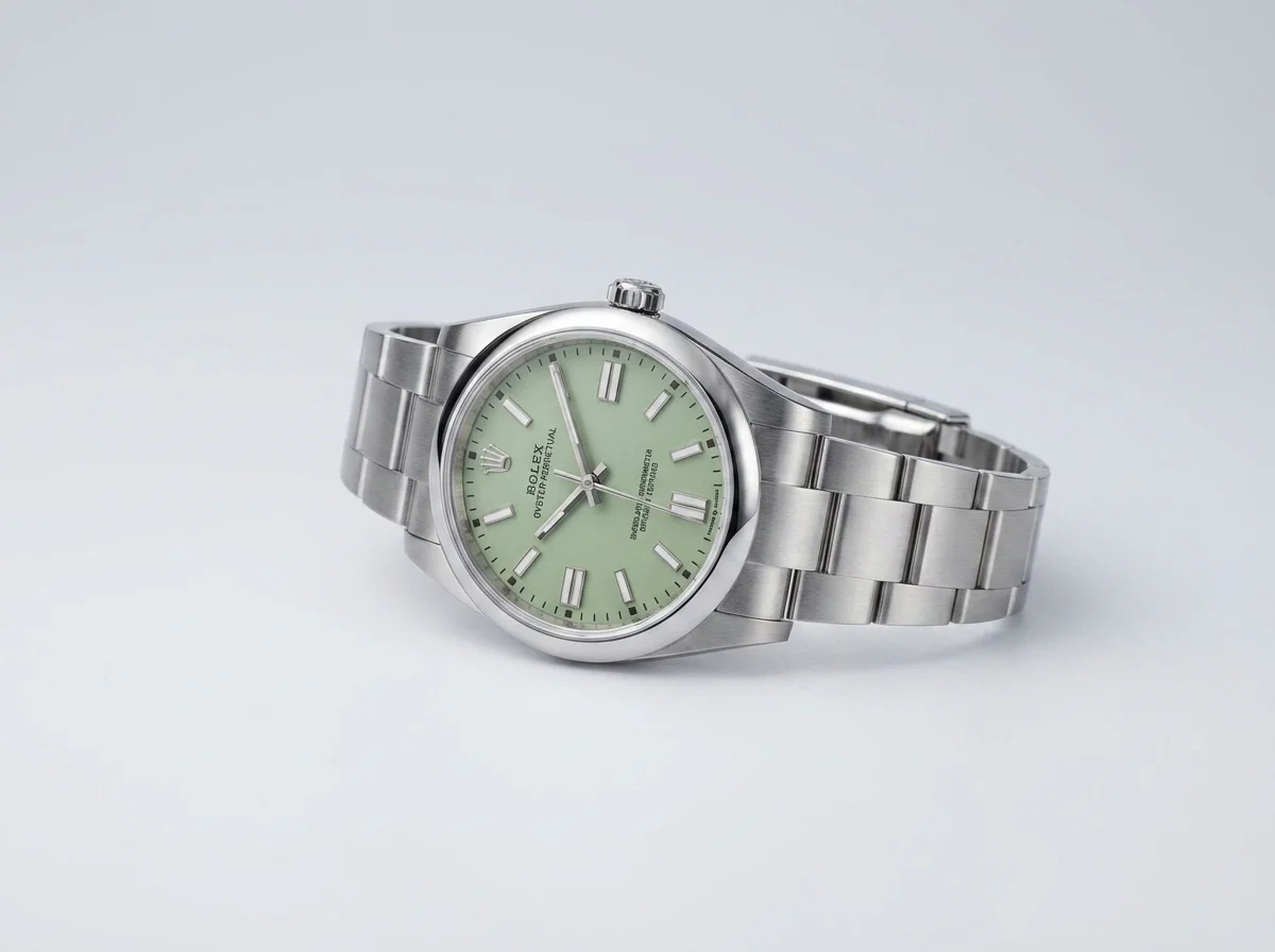 Rolex Oyster Perpetual 41 with a pistachio green dial on a grey studio background