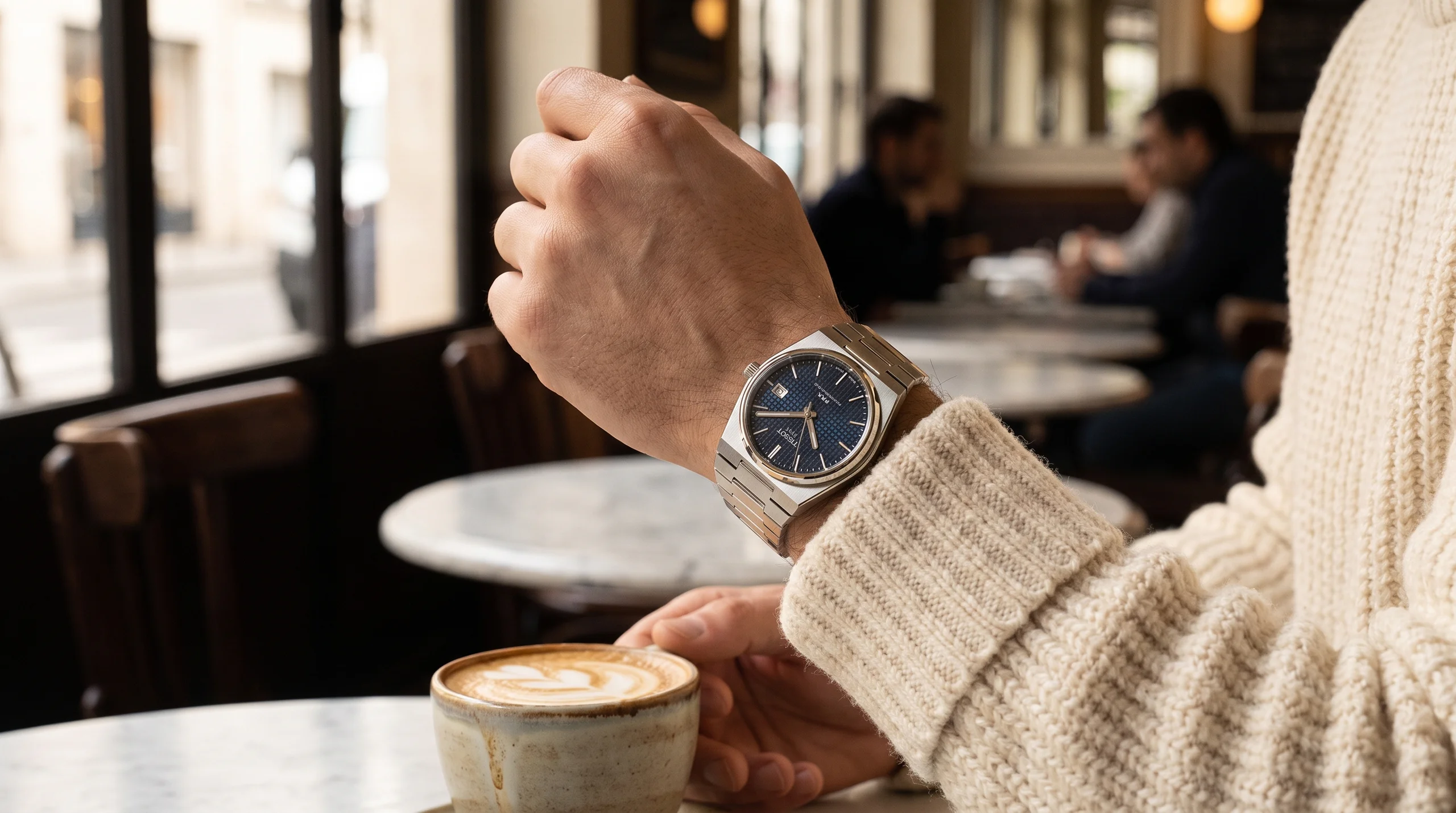 Tissot PRX Powermatic 80 worn on the wrist with a knit sweater cuff