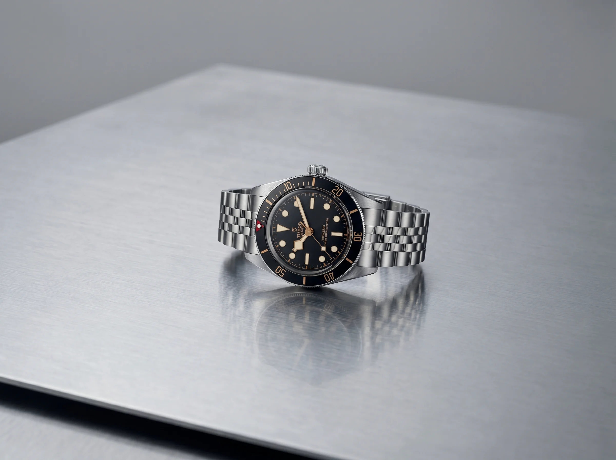 Tudor Black Bay 58 on a brushed steel surface in cool studio light
