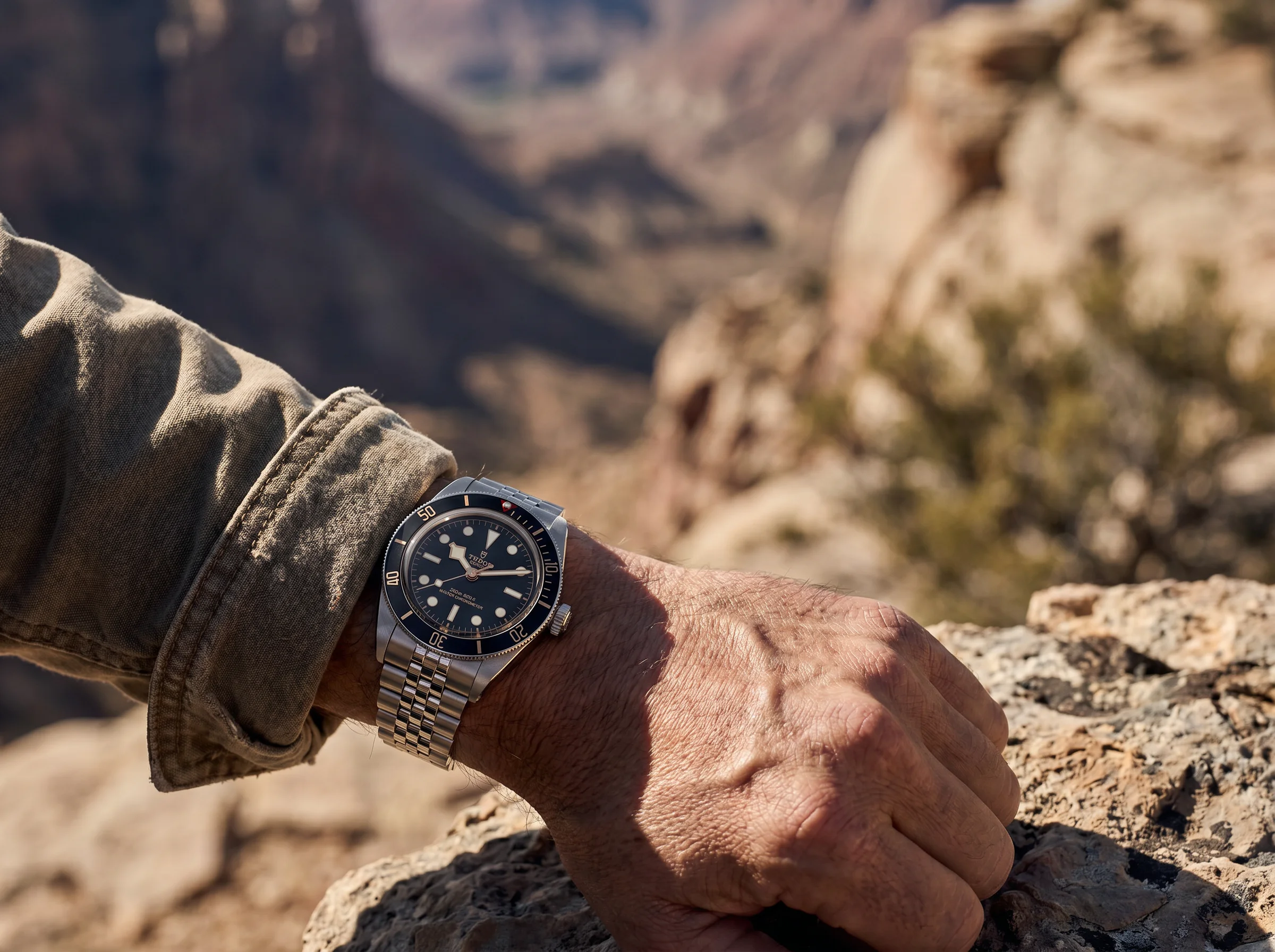 Tudor Black Bay 58 on a wrist outdoors with a rugged born-to-dare mood