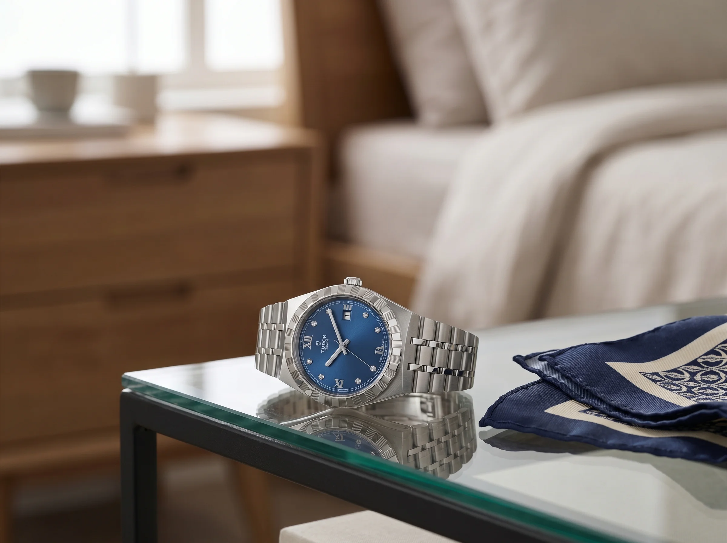 Tudor Royal 28500 with blue diamond dial and integrated bracelet on a glass dresser tray