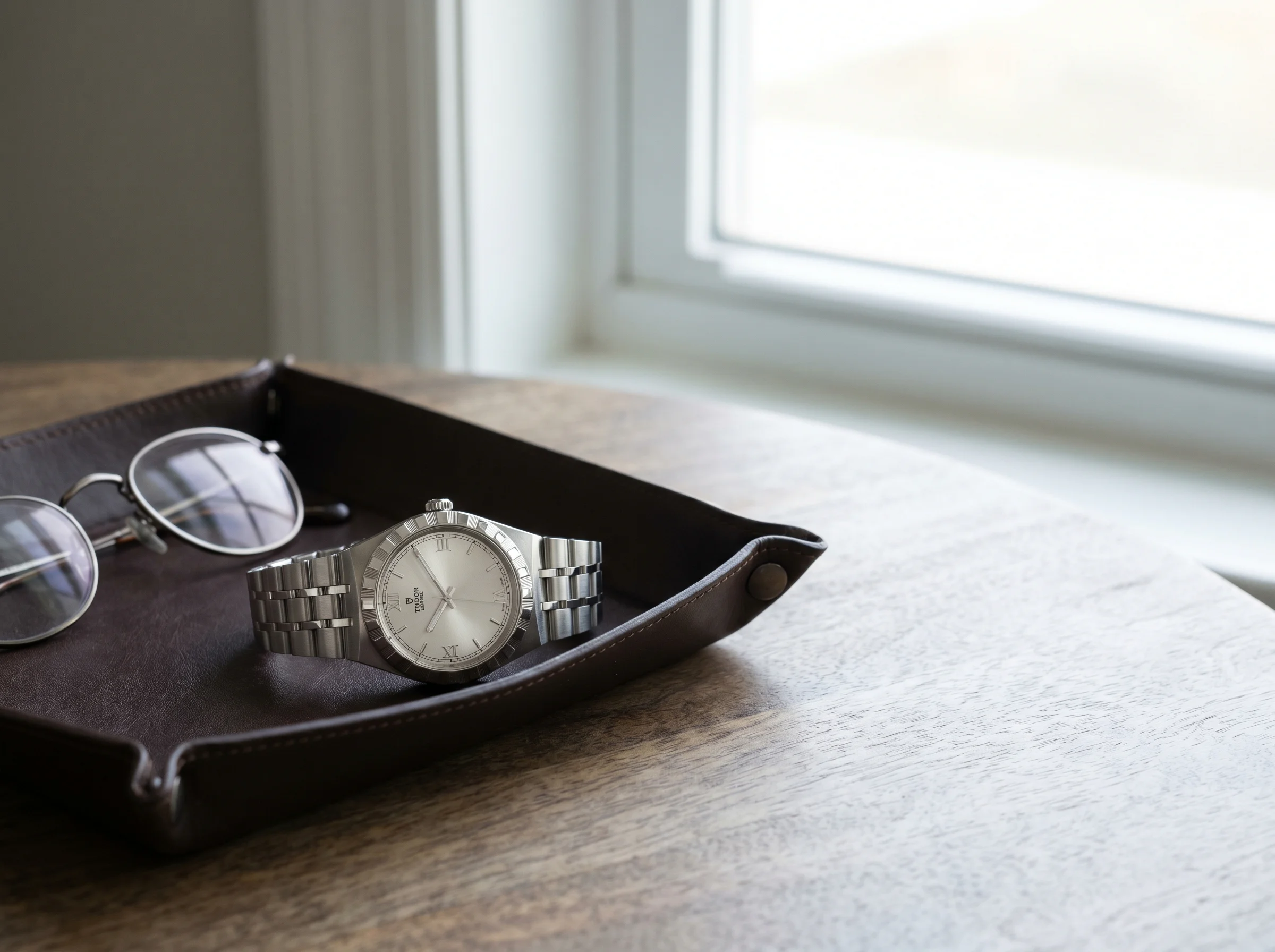Tudor Royal 30mm in steel with silver no-date dial on a dark leather tray
