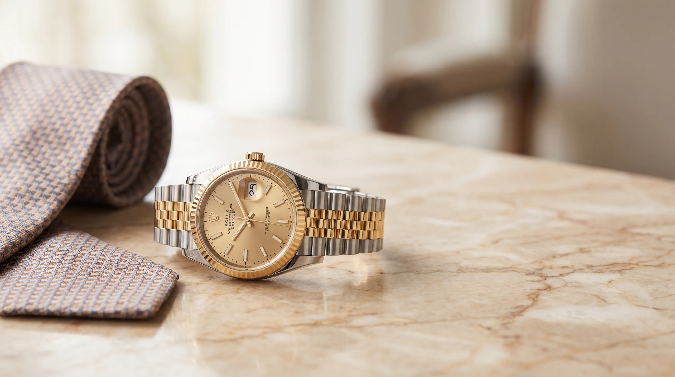 Rolex Datejust 36 two-tone steel and yellow gold with champagne dial on marble, the archetypal gold-steel watch
