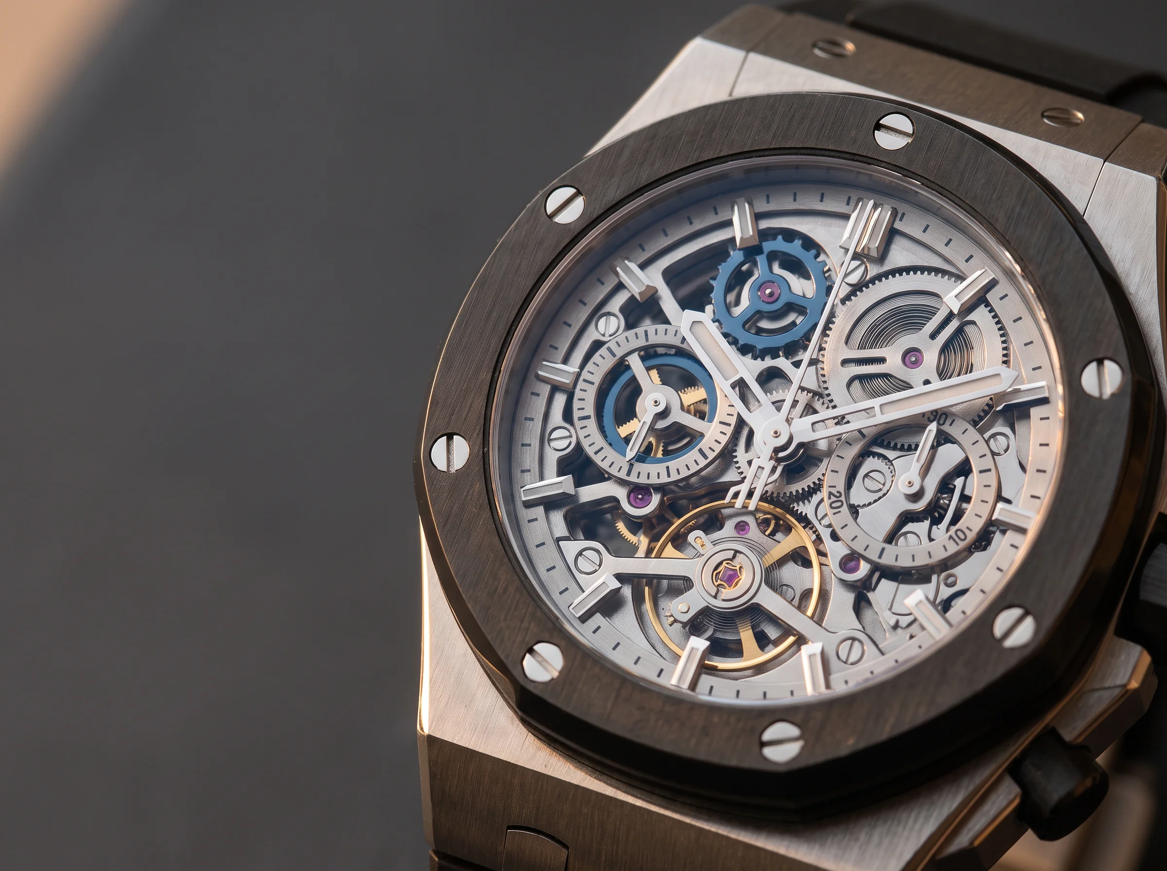 Close-up of an exposed openworked automatic chronograph movement with column-wheel finishing and screwed bezel