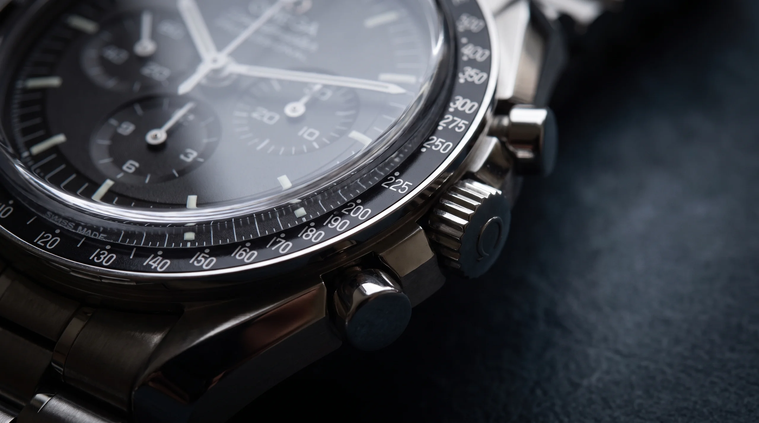 Close-up of a chronograph's pushers and tachymeter scale, the controls used to time an event