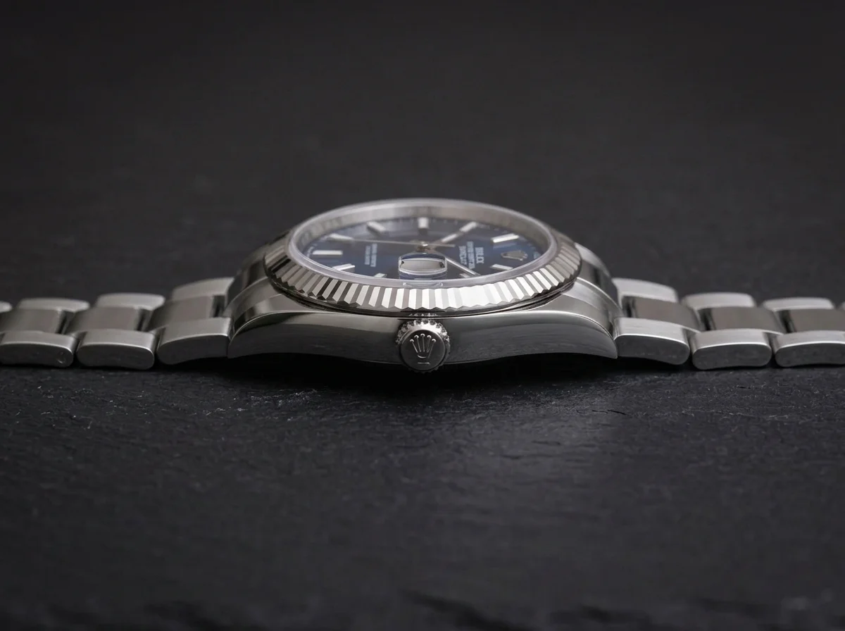 A Rolex Datejust shown in side profile emphasizing the lug-to-lug span and case thickness