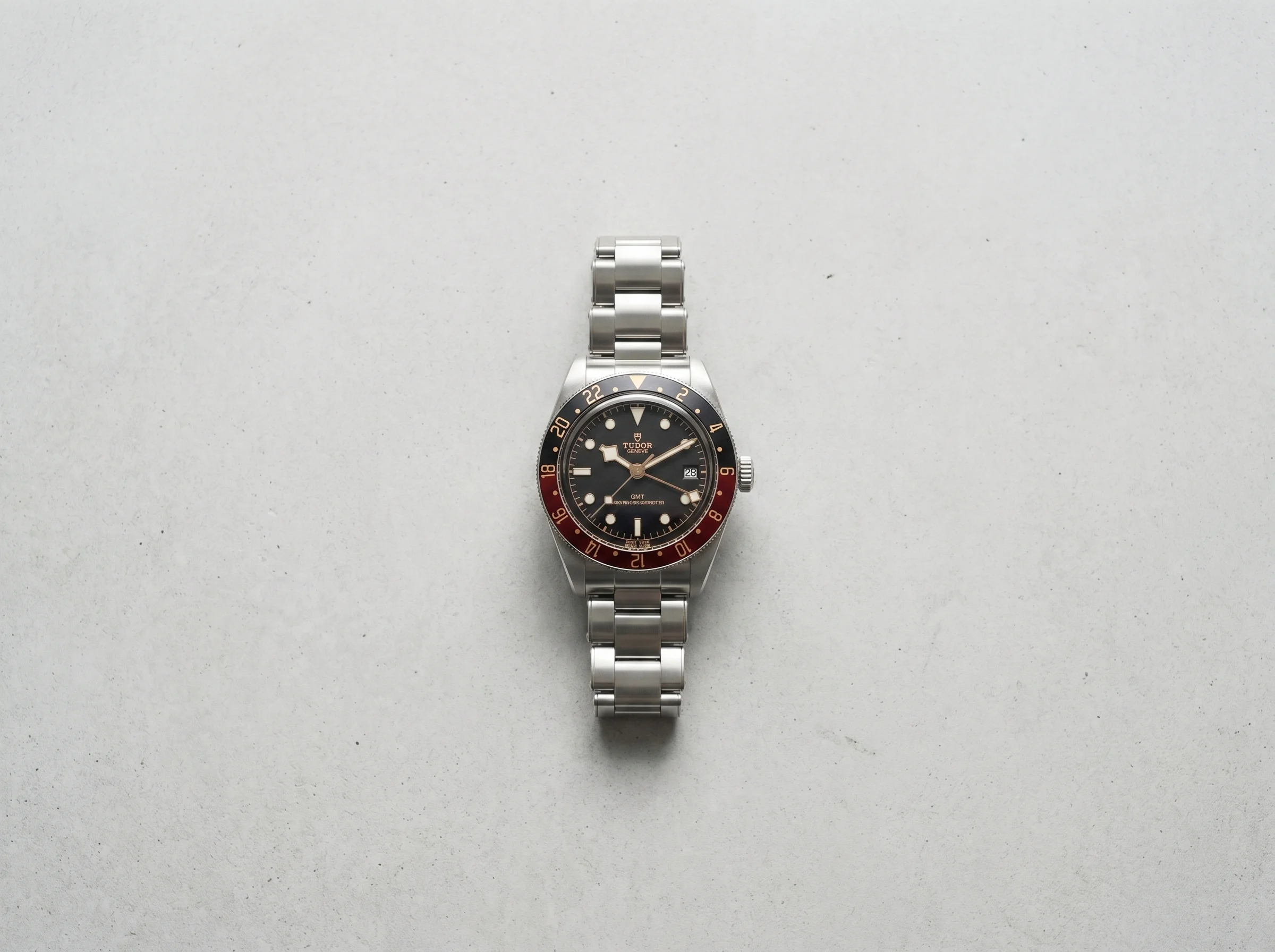 Top-down view of a GMT watch showing the 24-hour bezel and arrow-tipped GMT hand